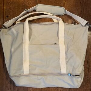 Lo & Sons Cream Duffel Bag with Spacious Design and Durable Material